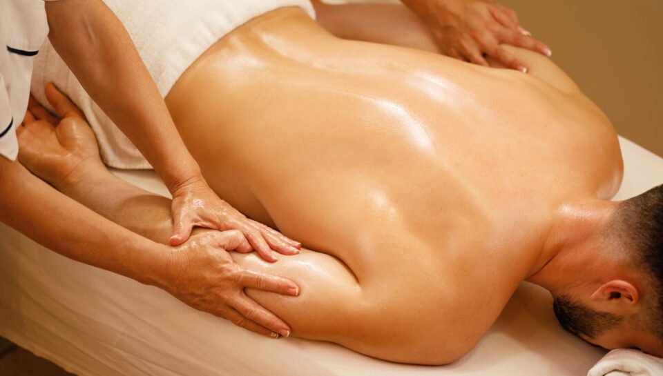 Unrecognizable man enjoying in relaxing massage at health spa.